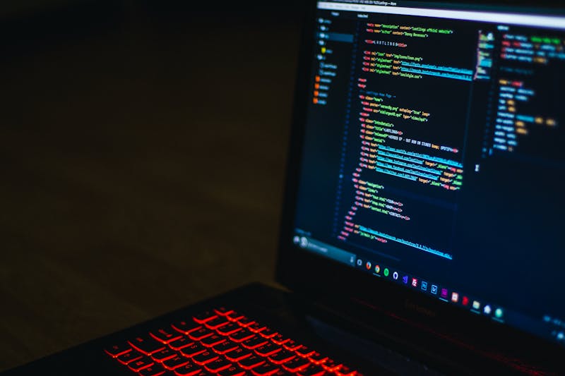 A laptop screen displaying code, representing student programming
